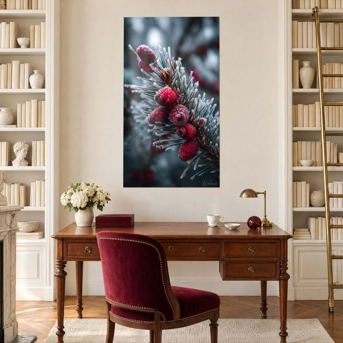 Wall art of a frosted pine branch with red beads, soft blurred blue-grey background, above a wooden desk and a burgundy armchair