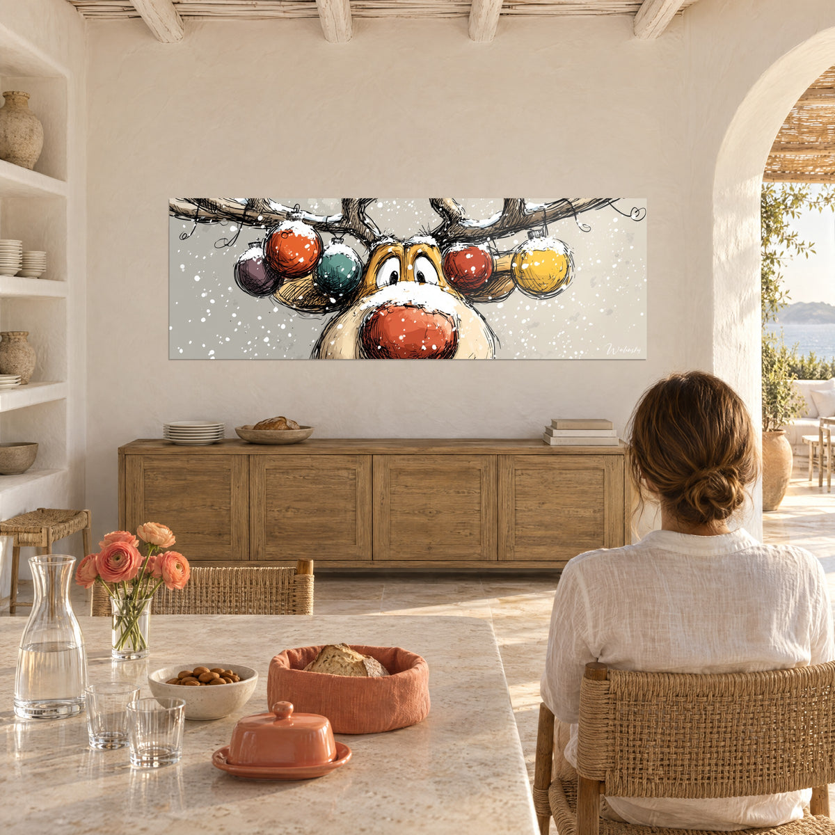 Quadro caribù da cartone animato con muso rosso spolverato di neve, palline viola e arancioni, di fronte a una donna seduta di spalle