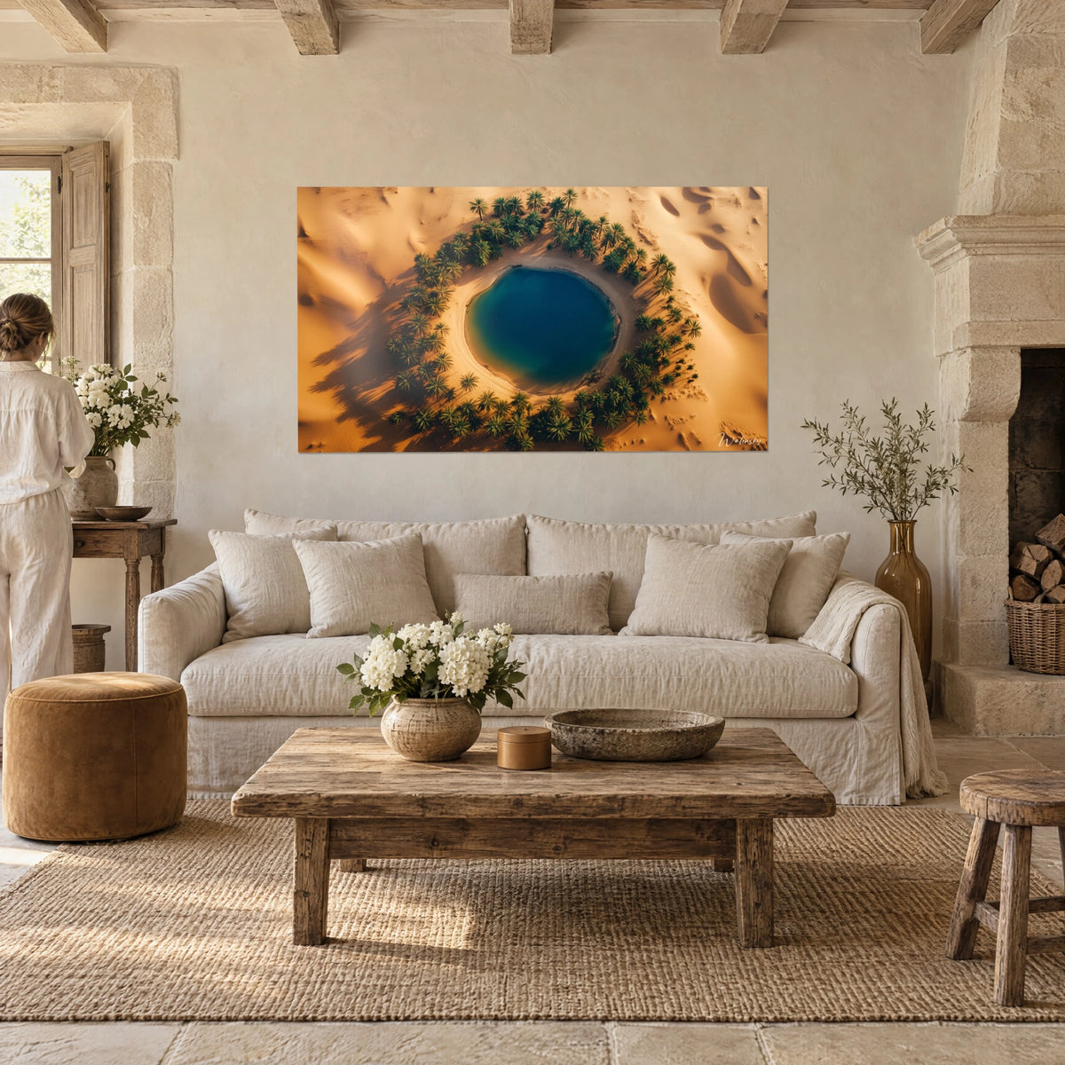 Wall art turquoise oasis ringed by green palm trees on golden dunes, aerial view, above a sofa in a bright living room
