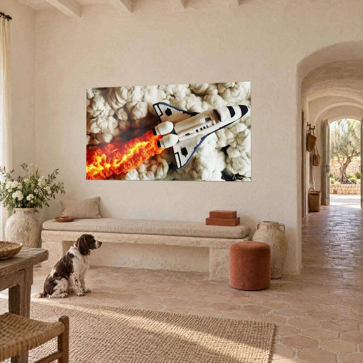 Wall art knitted rocket in white and black, orange fire trail over wool clouds, farmhouse wall, spaniel sitting beside the bench