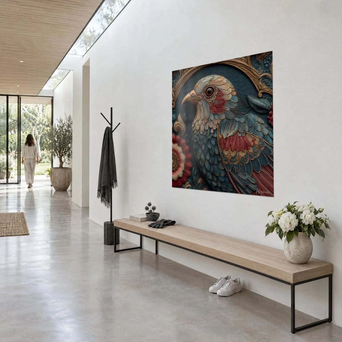 Wall art bird portrait adorned with chiselled blue and purple feathers, red flower on the left, seen at an angle in an architect's house hallway