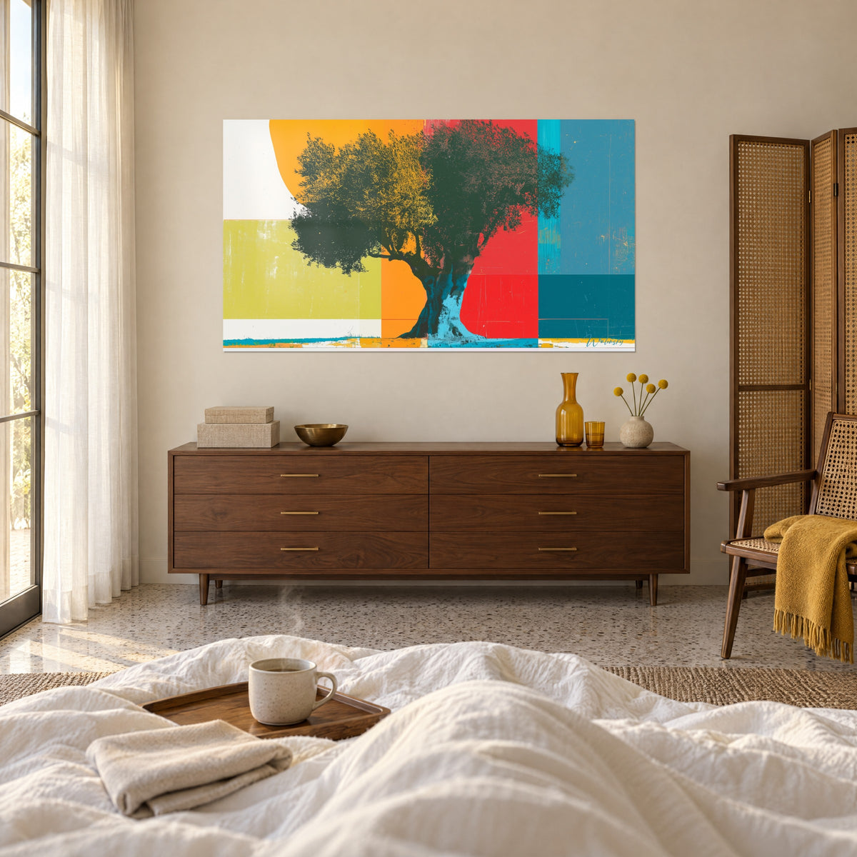 Wall art olive tree silhouette with dense branches, orange, red and duck blue blocks, facing a chest of drawers, above a bed in a light bedroom