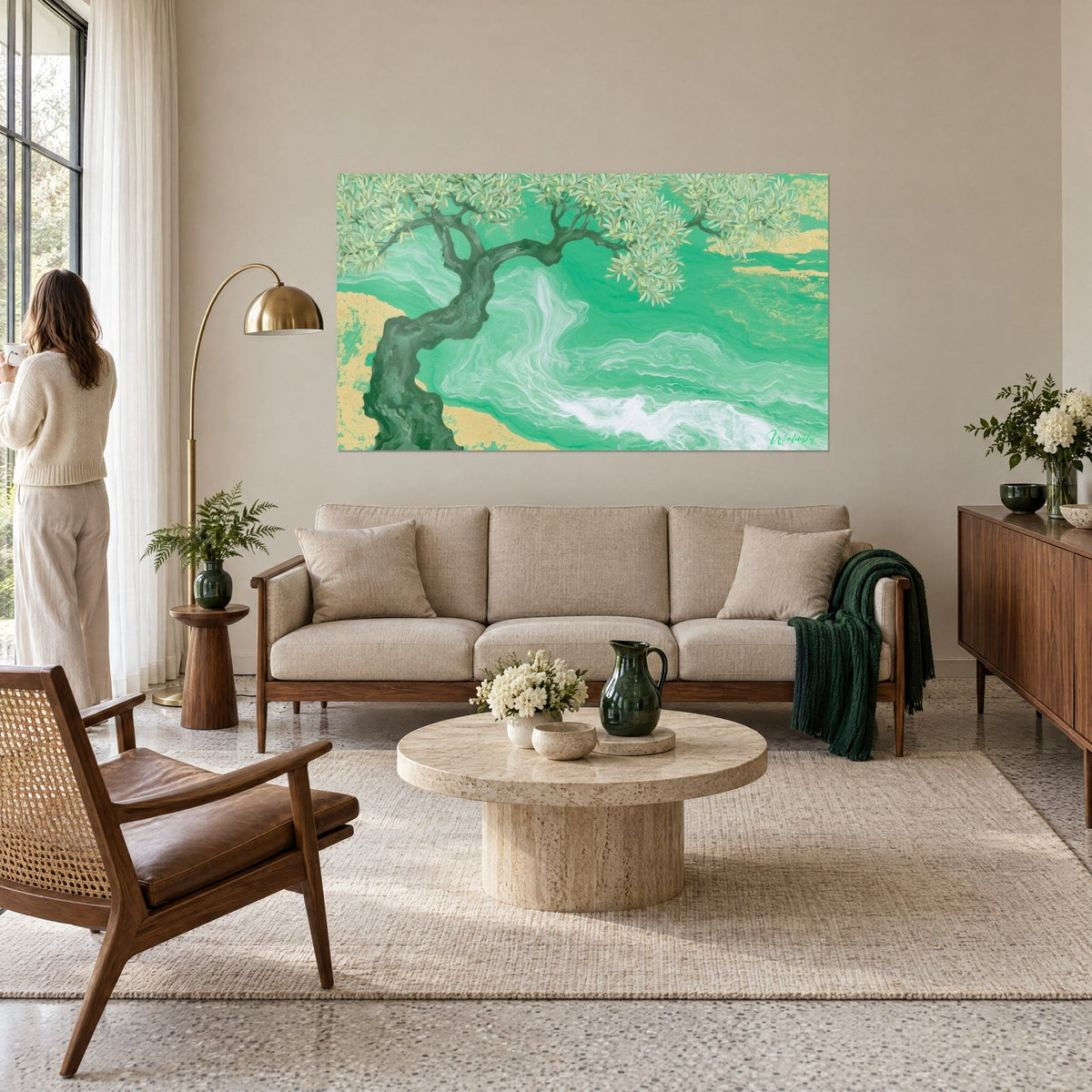 Wall art gnarled olive tree with dark green trunk over emerald sea marbled with gold leaf, above a sofa in a bright living room