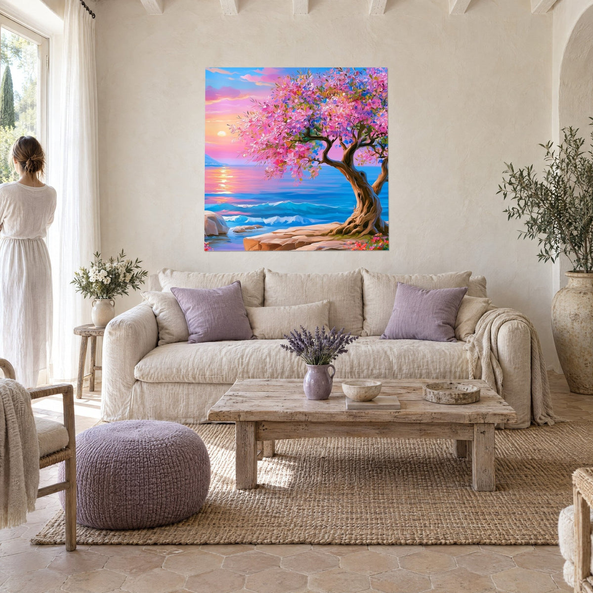 Tableau olivier en fleurs rose vif sur mer bleue et soleil couchant, au-dessus d'un canapé dans un salon lumineux