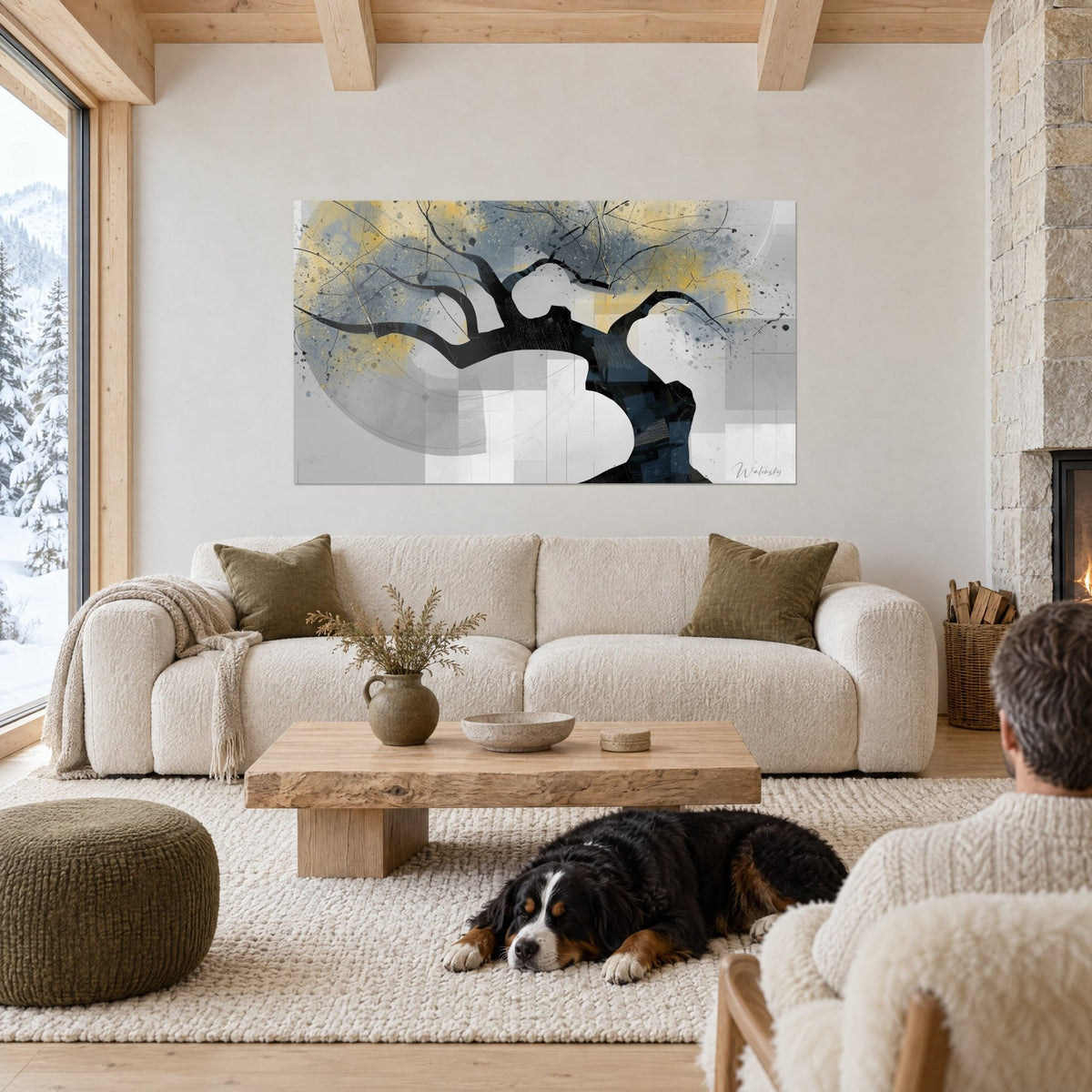 Wall art black olive tree with gnarled branches, gold and grey glow, two people and a dog above a sofa in a bright living room