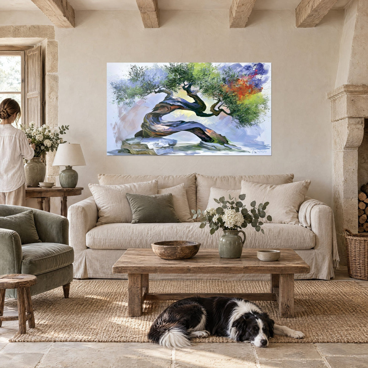 Wall art olive tree with a winding trunk in green and orange, bluish watercolor foliage, reclining collie, above a sofa in a bright living room
