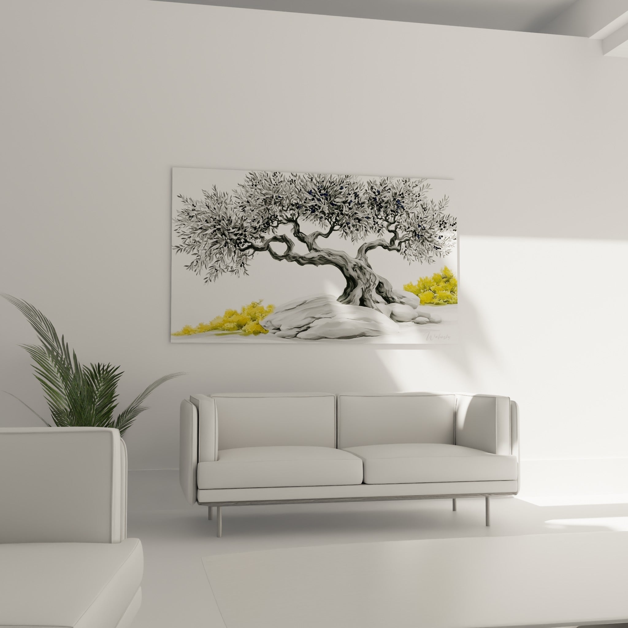 Branches argentées et rochers gris de l'olivier suspendues au-dessus d'un canapé dans un salon lumineux