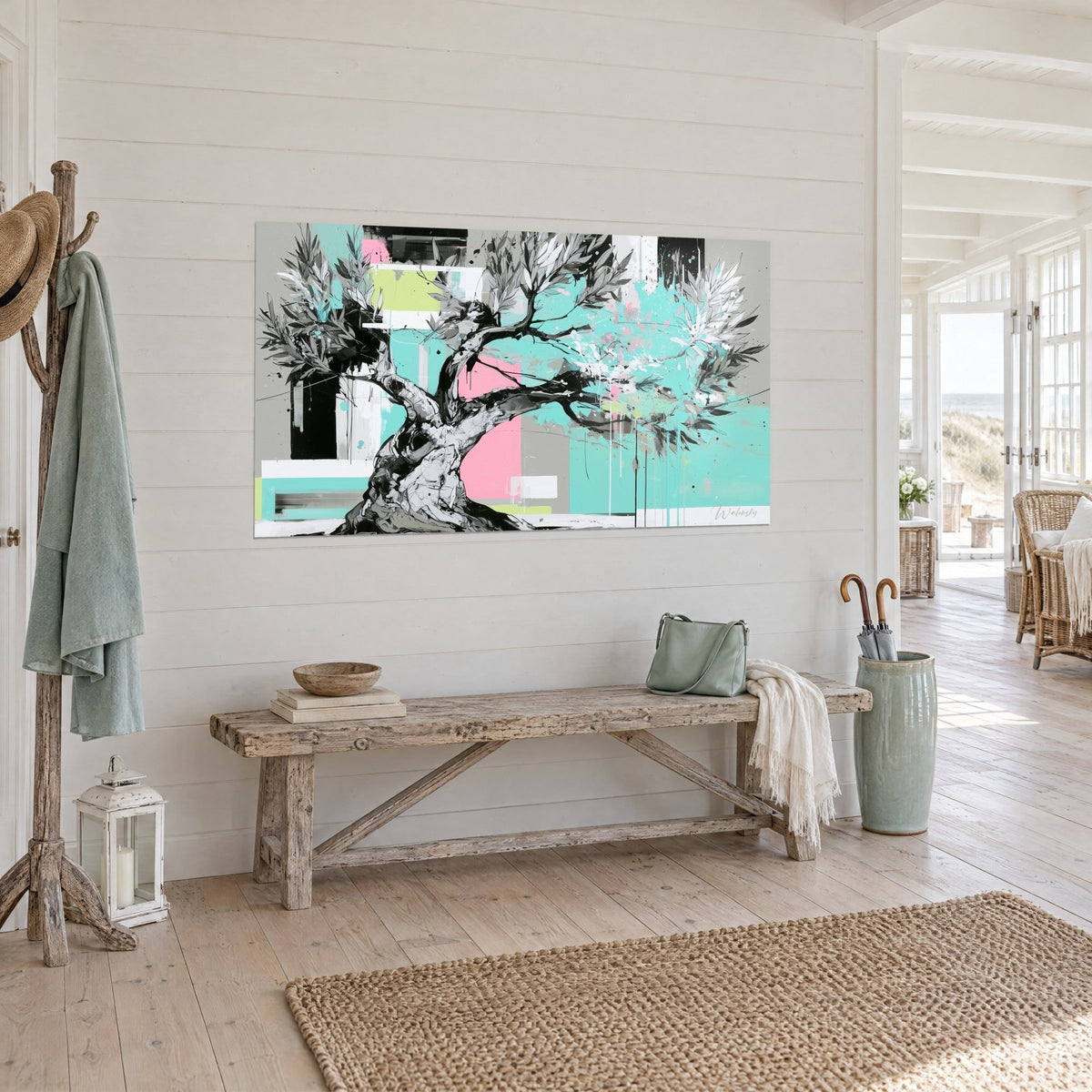 Wall art tormented tree with slender branches, white splashes on turquoise, pink and anise green blocks, on the white wall of a beach house