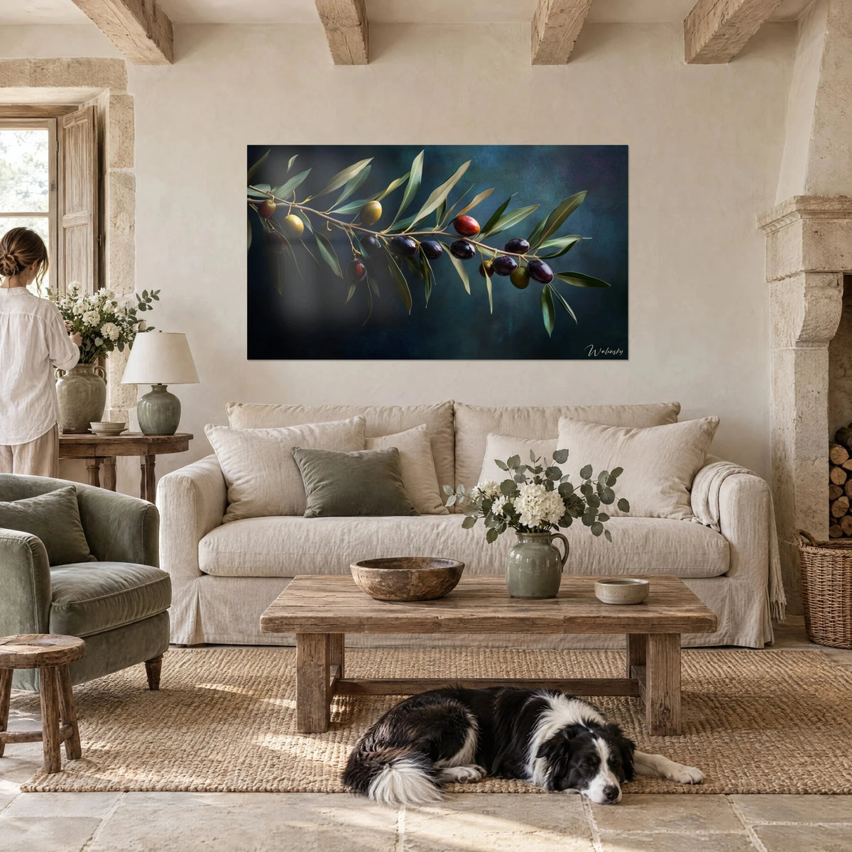Wall art olive branch laden with black and green olives on a midnight blue background, above a sofa in a bright living room