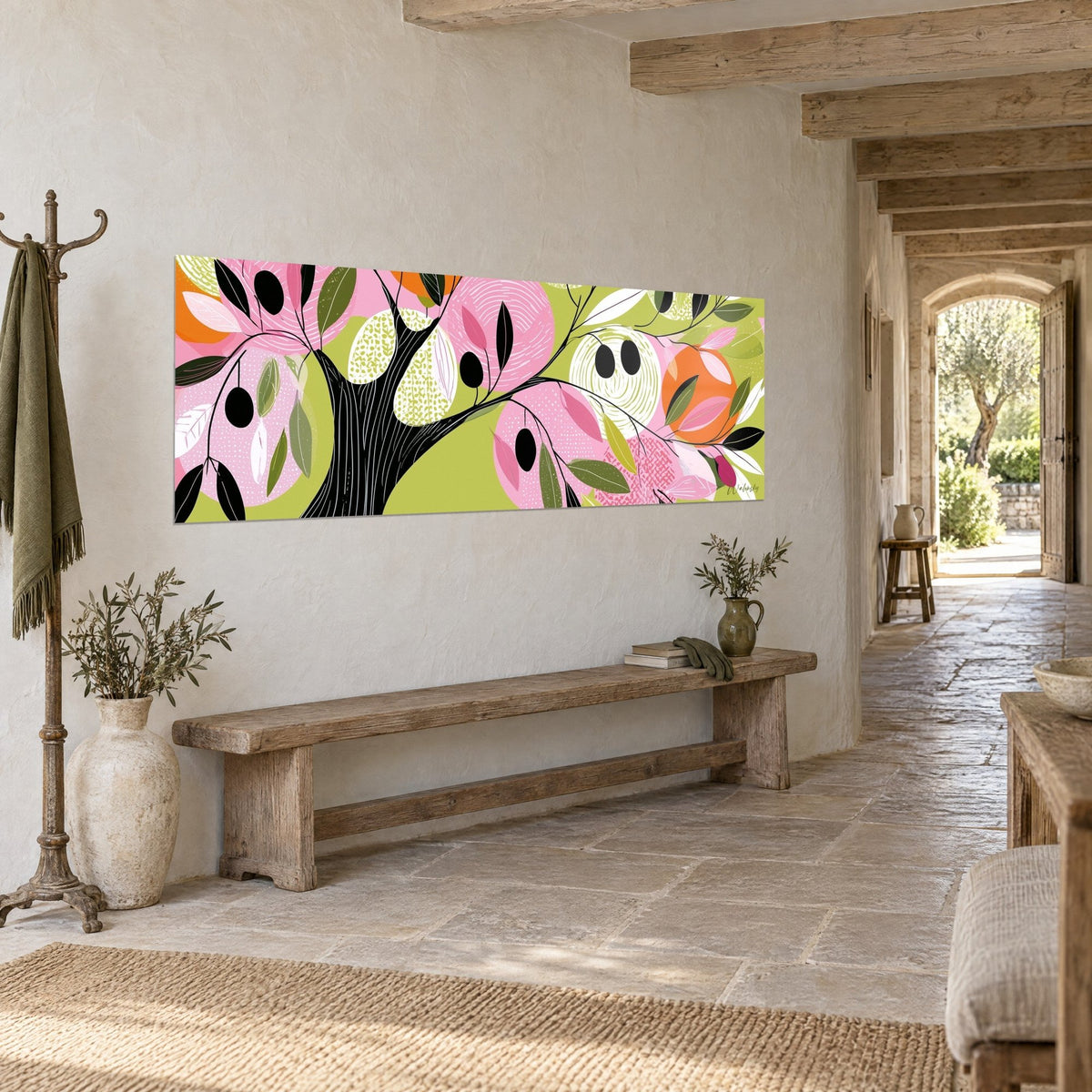 Wall art graphic olive tree, striped black trunk, pink and orange circles, three-quarter view in a stone hallway
