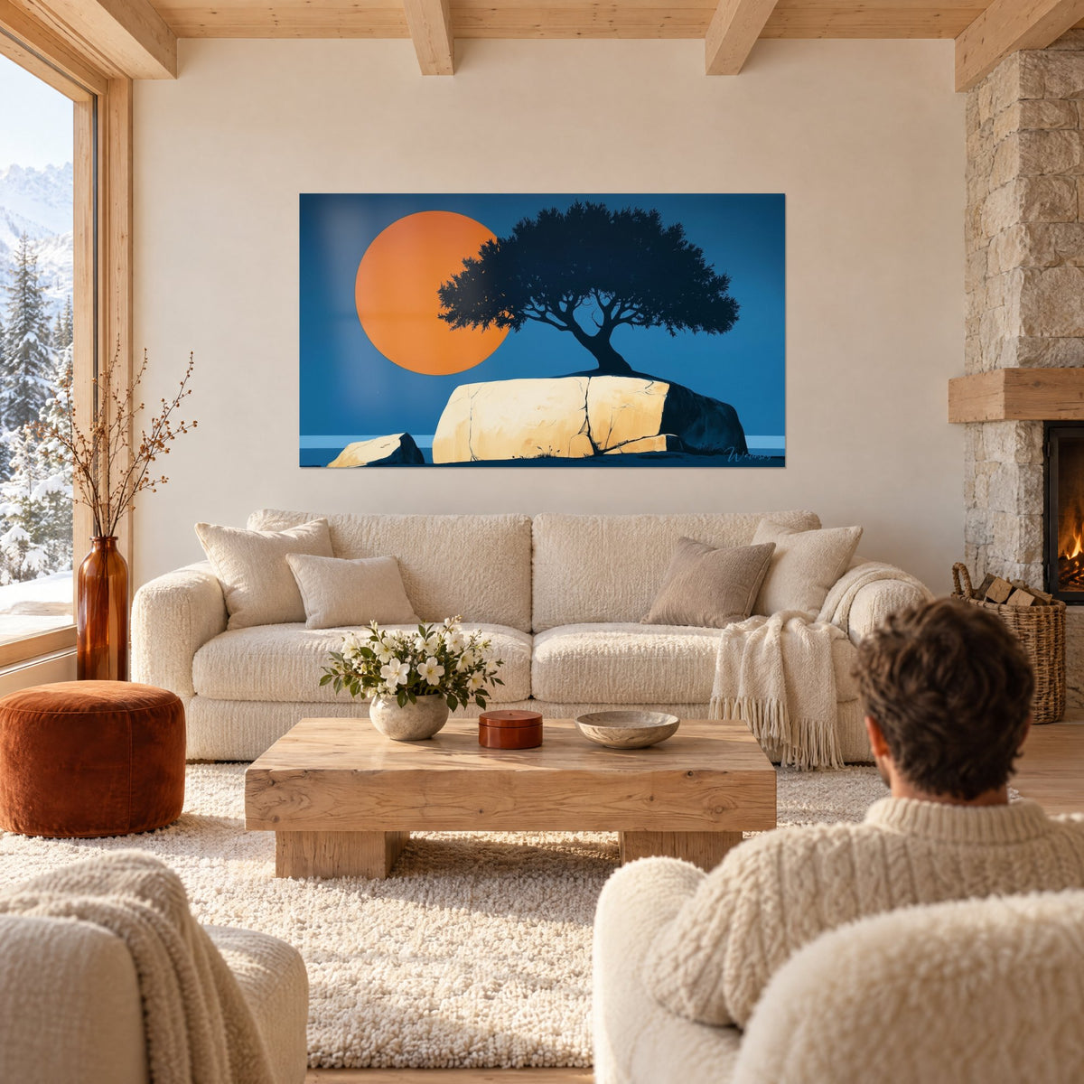 Tableau olivier en ombre chinoise sur un rocher crème fissuré, disque orange et ciel bleu, au-dessus d'un canapé dans un salon lumineux