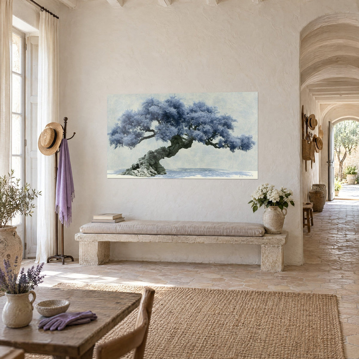 Wall art of a twisted tree with periwinkle blue tufts of foliage and moss-covered grey-green roots, whitewashed wall and vaulted corridor of a Provençal farmhouse
