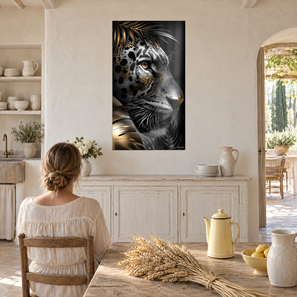 Wall art jaguar with an amber gaze, black rosettes and gold highlights on a night background, hung near a wall of white crockery