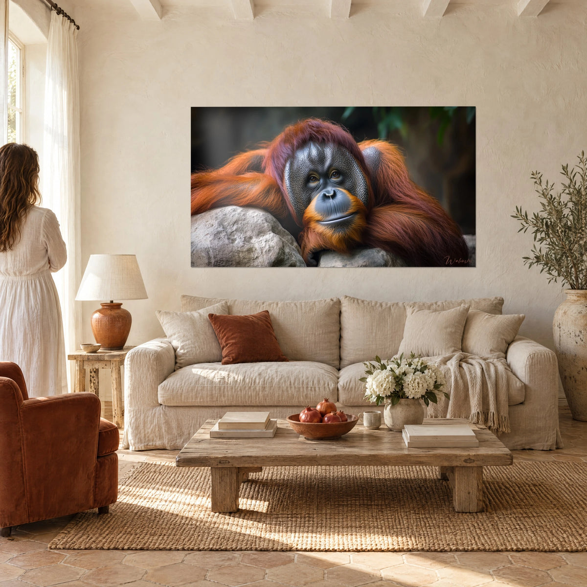Wall art red orangutan with a gentle gaze, coppery grey face on a pale rock, above a sofa in a bright living room