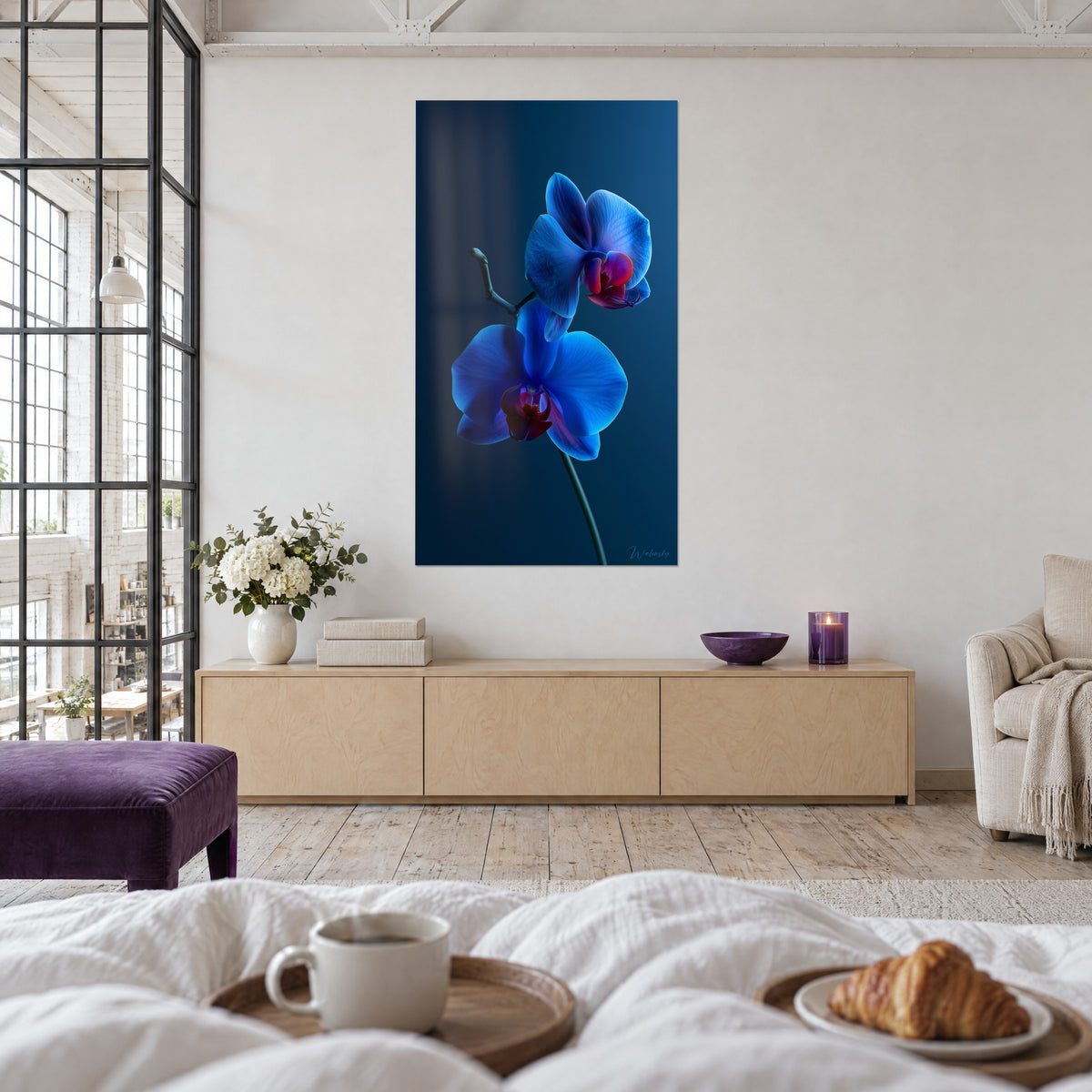 Cuadro dos flores de orquídea azul real con centro burdeos sobre fondo noche, frente a una cama blanca, encima de una cama en un dormitorio luminoso