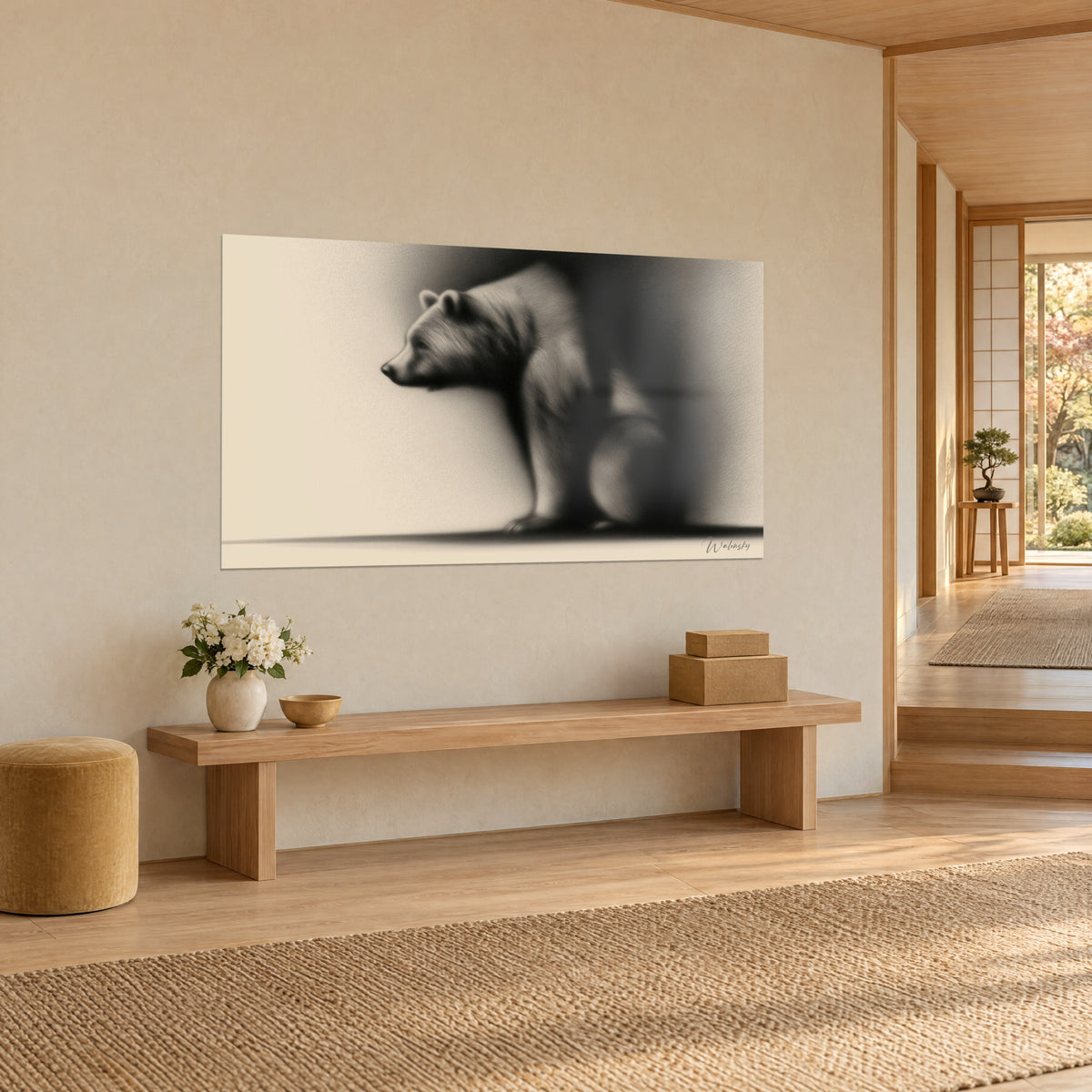 Wall art of a seated grizzly in profile, black gradient shadow on cream, mounted near a light wood bench in a Japandi living space