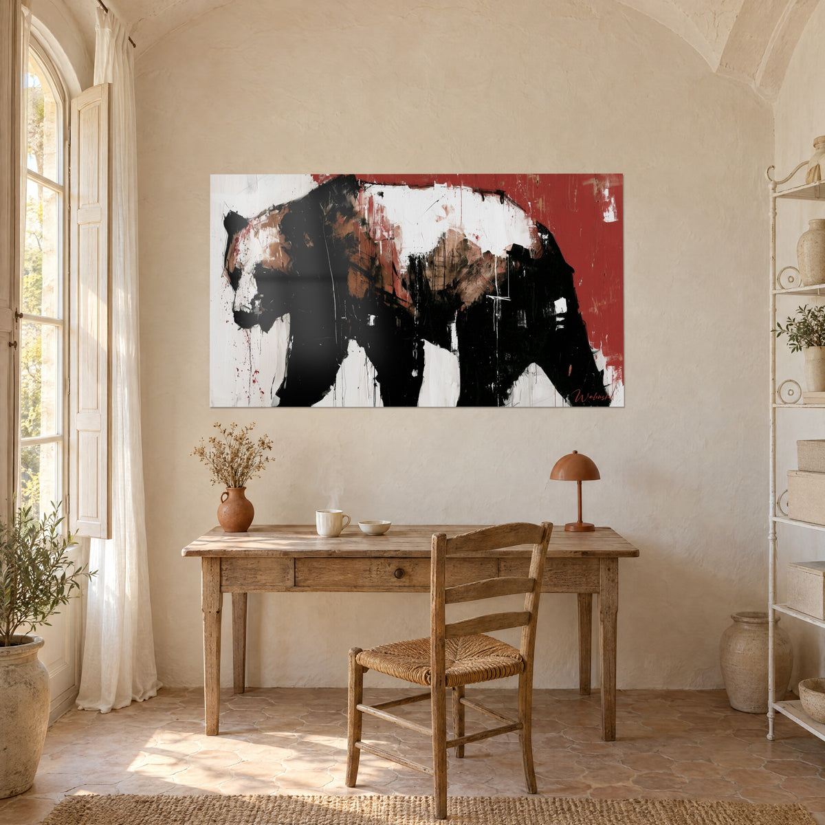 Wall art gesturally painted bear silhouette, deep black, chalk white and blood red, above a light wood desk