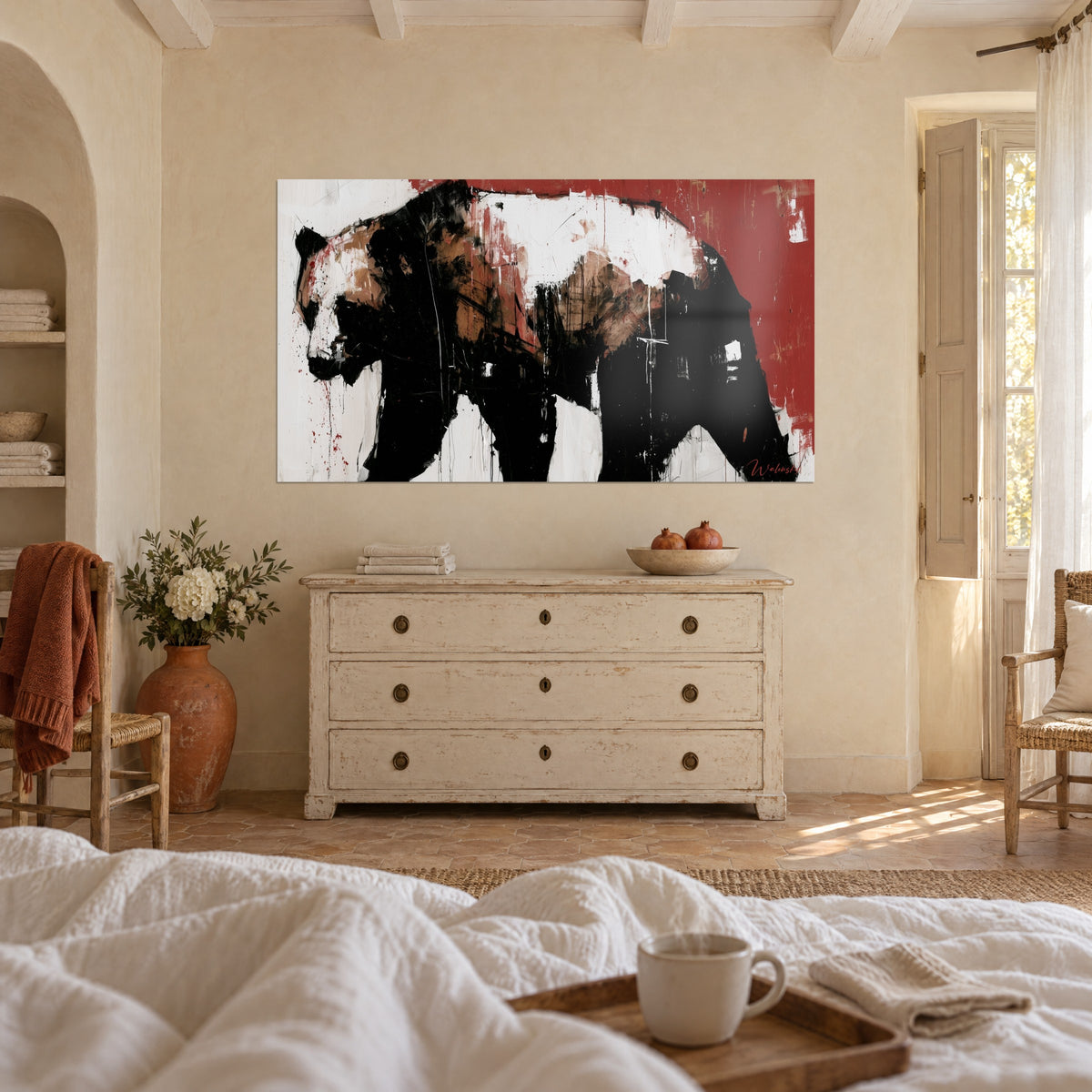Wall art large brown and black bear with red drips on a white background, hung above a bed in a bright bedroom