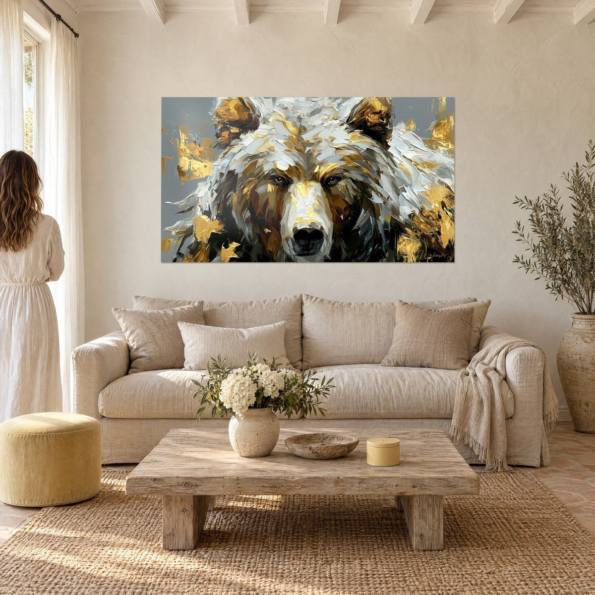 Wall art of a white bear with textured fur, golden highlights and amber eyes, hanging above a sofa in a bright living room