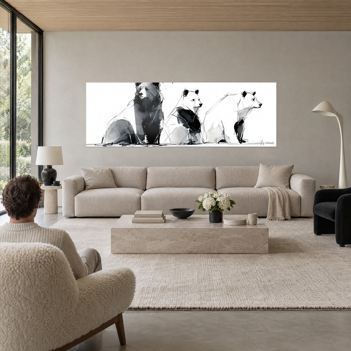 Tableau trio d'ours en encre noire et grise, pelage blanc laissé nu sur fond clair, au-dessus d'un canapé dans un salon lumineux