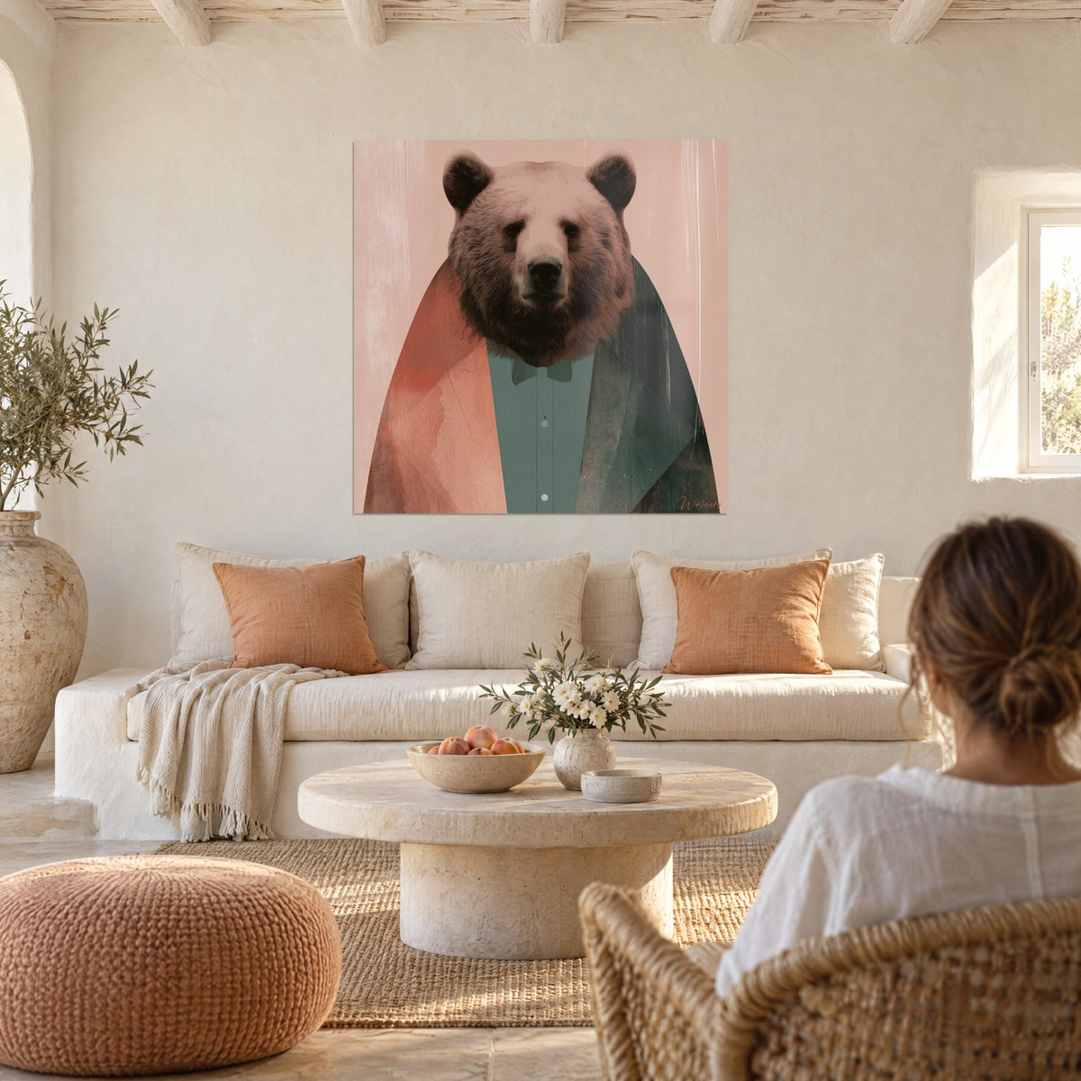 Wall art brown bear in terracotta jacket and sage green shirt, powder pink background, above a sofa in a bright living room