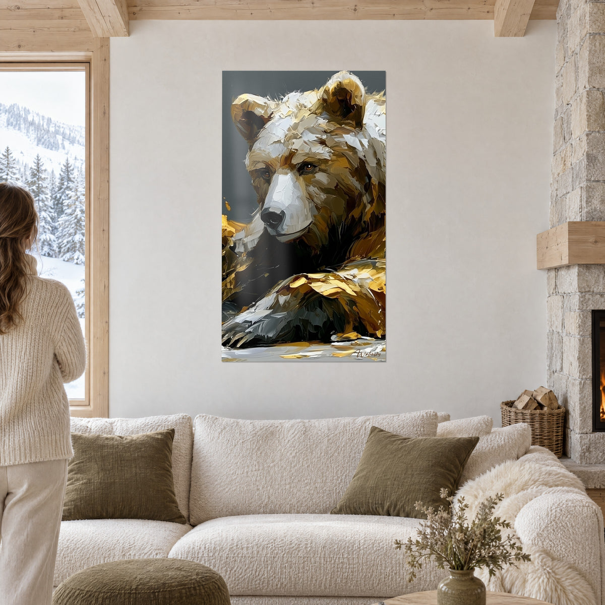 Wall art of a reclining brown bear, white muzzle and ochre fur in palette-knife strokes, couple seen from behind above a sofa in a bright living room