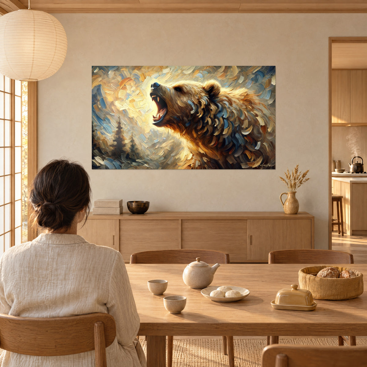 Wall art of a roaring bear in oil paint, muzzle raised high, honey and steel-blue fur, beige wall, a woman seen from behind seated at a table near a bay window