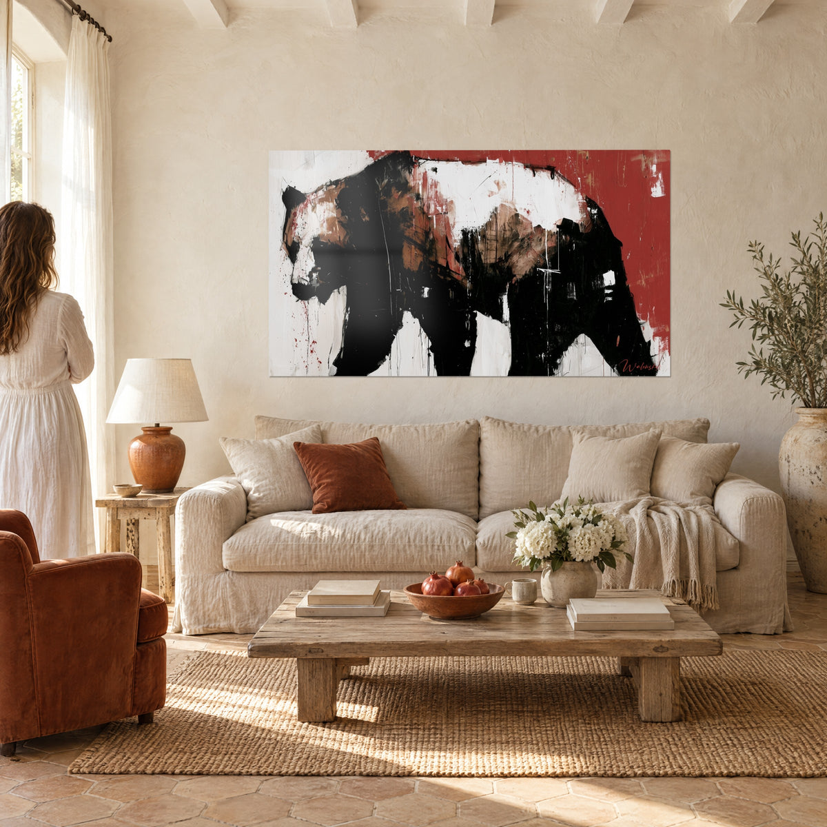 Wall art massive bear in solid black and white blocks on a brick red background, above a sofa in a bright living room