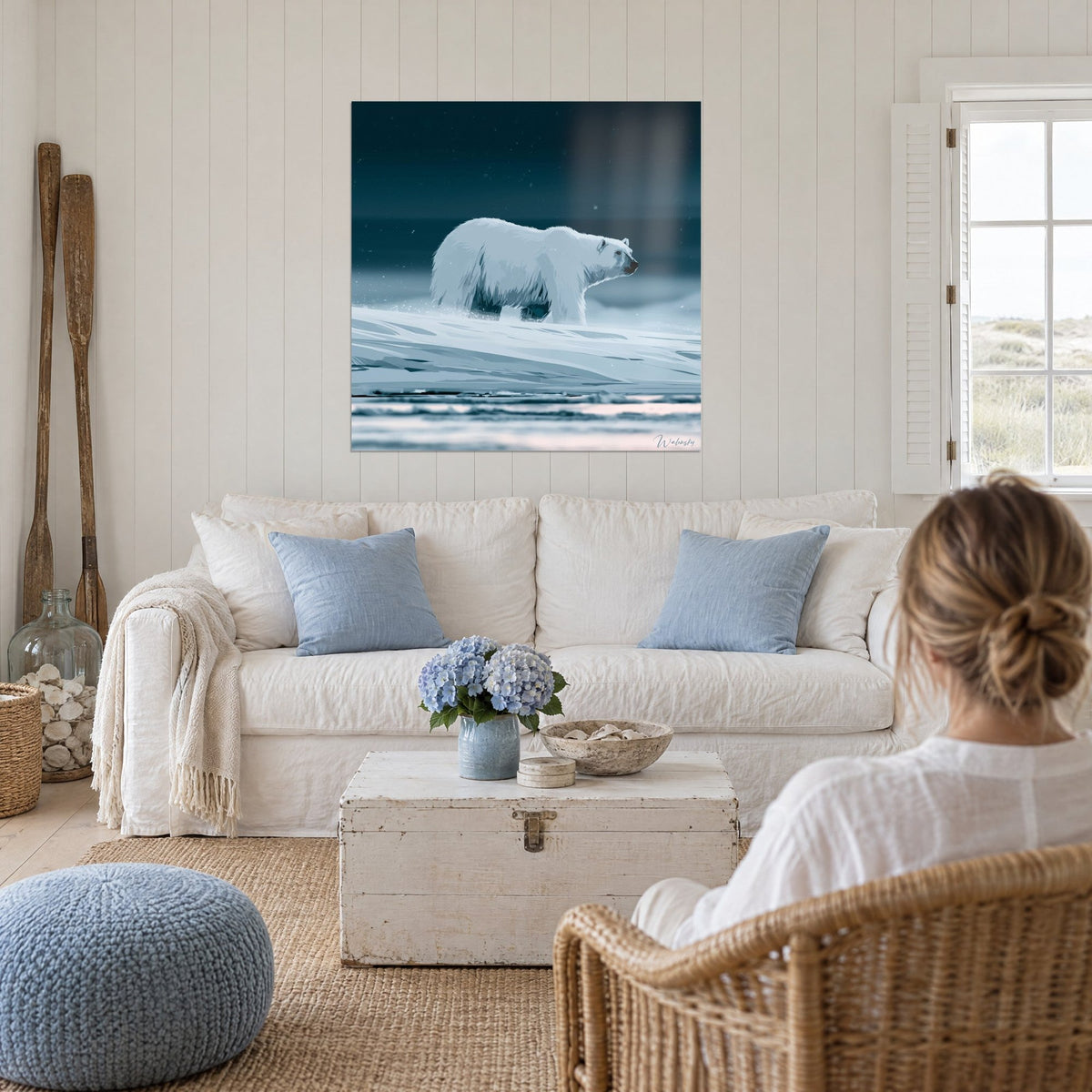 Wall art polar bear with frosted glacier-blue fur, midnight-blue sky, hung above a sofa in a bright living room