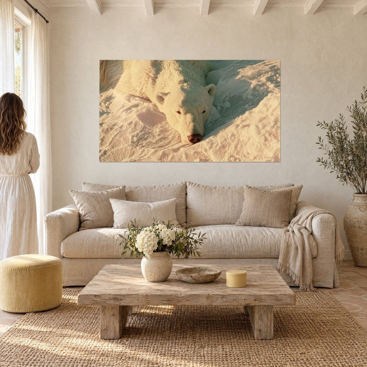 Wall art sleeping white polar bear on golden snow, pink snout, cream fur, couple seen from behind, above a sofa in a bright living room