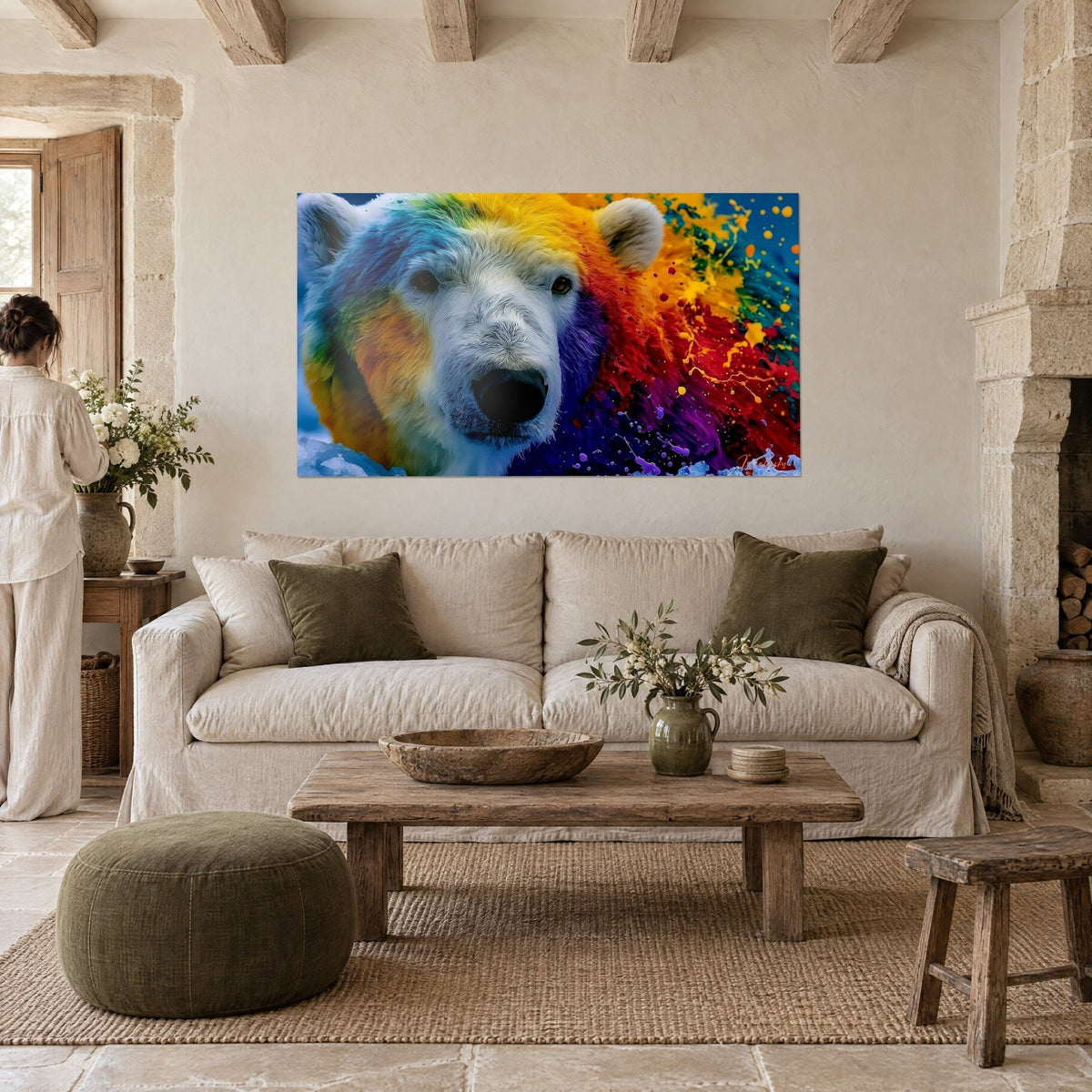 Wall art polar bear with yellow and blue fur splashed with red, viewed from behind by a woman, above a sofa in a bright living room