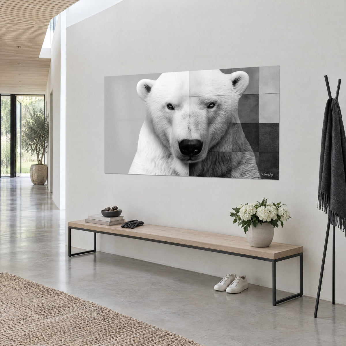 Wall art white polar bear with pale eyes, black muzzle and charcoal grey squares, hung on a beige wall beside a wooden bench