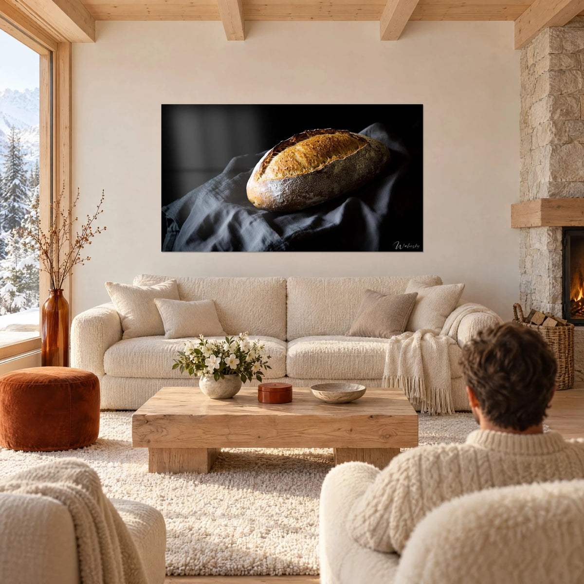 Wall art rustic country loaf with golden crust on charcoal grey linen, black background, above a sofa in a bright living room