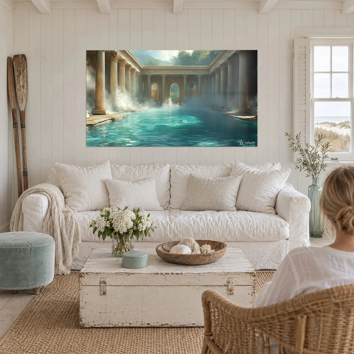 Wall art of ancient thermal baths with golden columns, turquoise water and white mist, above a sofa in a bright living room
