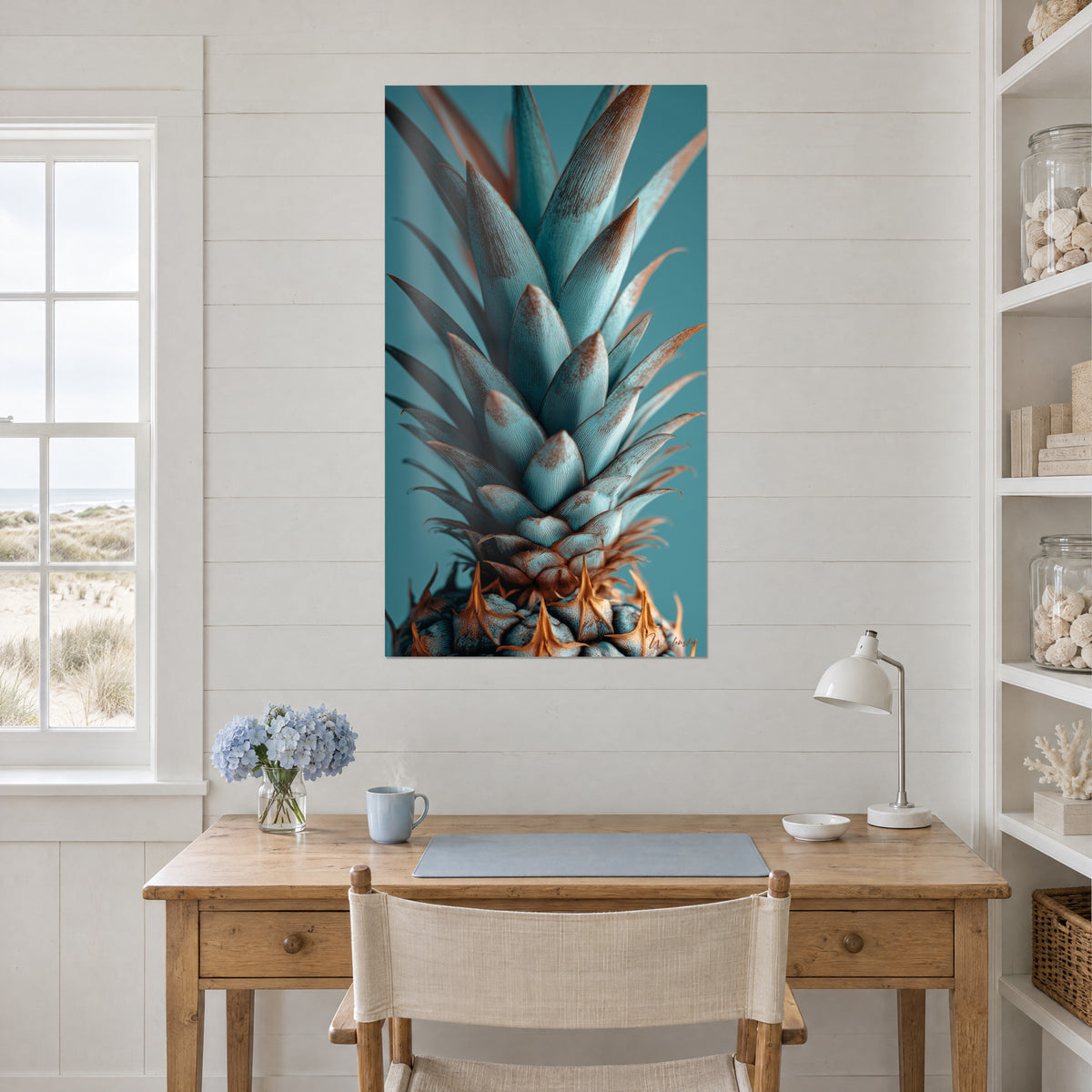 Tableau cime d'ananas aux nervures cuivrées sur fond sarcelle, accroché au-dessus d'un bureau en bois clair