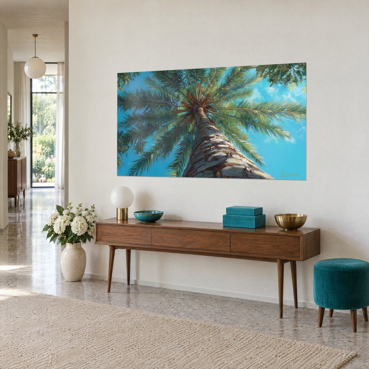 Wall art palm tree crown in low-angle view, deep green fronds and azure blue sky, hung above a wooden console table