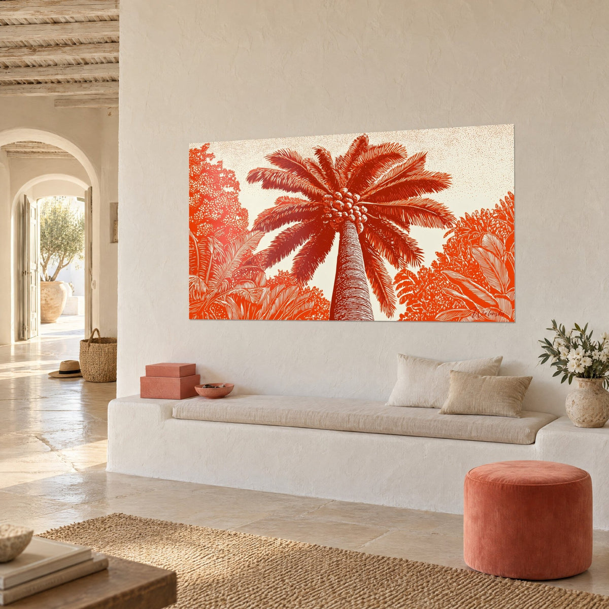 Wall art palm leaf wreath in vivid orange on a cream background, date clusters at the centre, hung at an angle above a white bench and a coral pouf