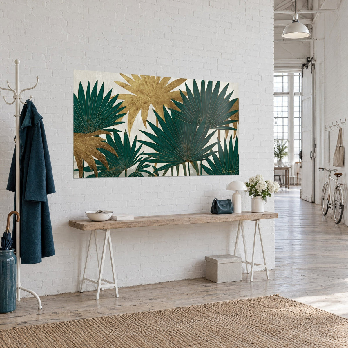 Wall art with deep green and gold palm fronds with fine veining, hung above a wooden console table