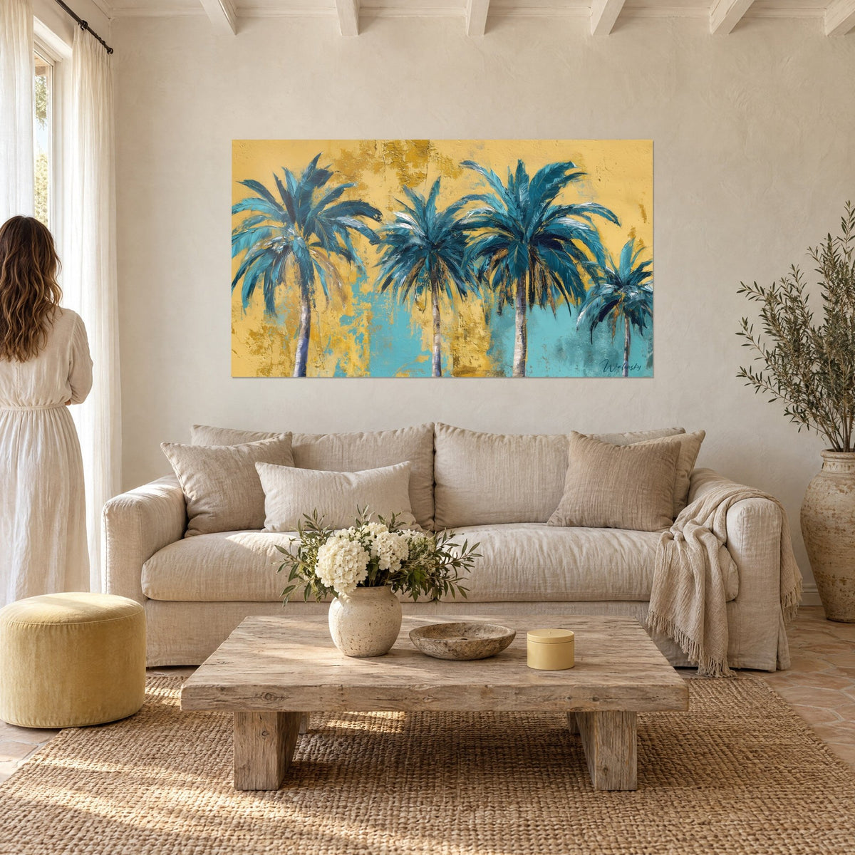 Wall art turquoise palms with white sequin-like fronds on golden ochre background, couple seen from behind, above a sofa in a bright living room