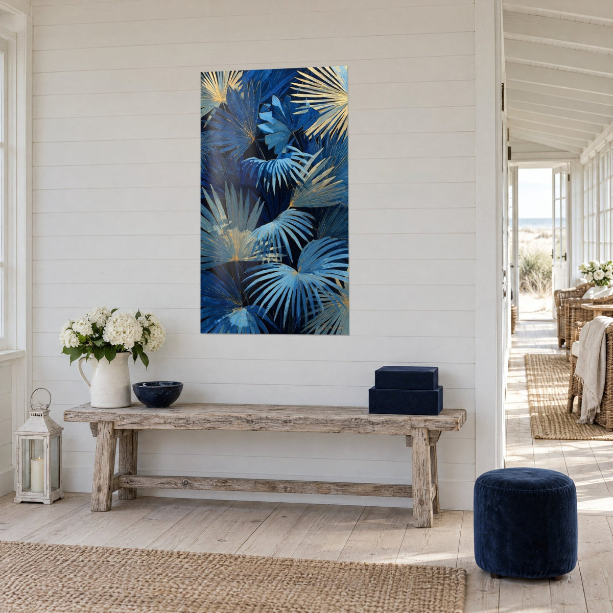 Wall art with azure palm fronds on a night-black background, golden highlights, white plank wall and a weathered bench by the sea