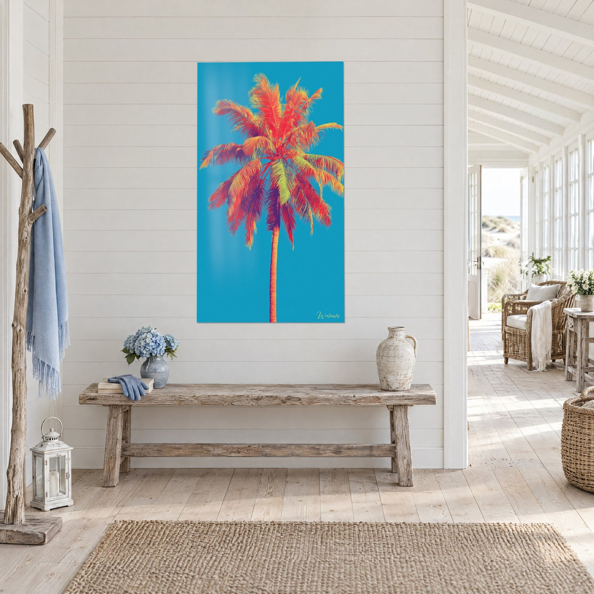 Quadro palma pop art con fronde rosse e viola, sfondo blu turchese, su una parete in perlinato bianco accanto a una panca rustica