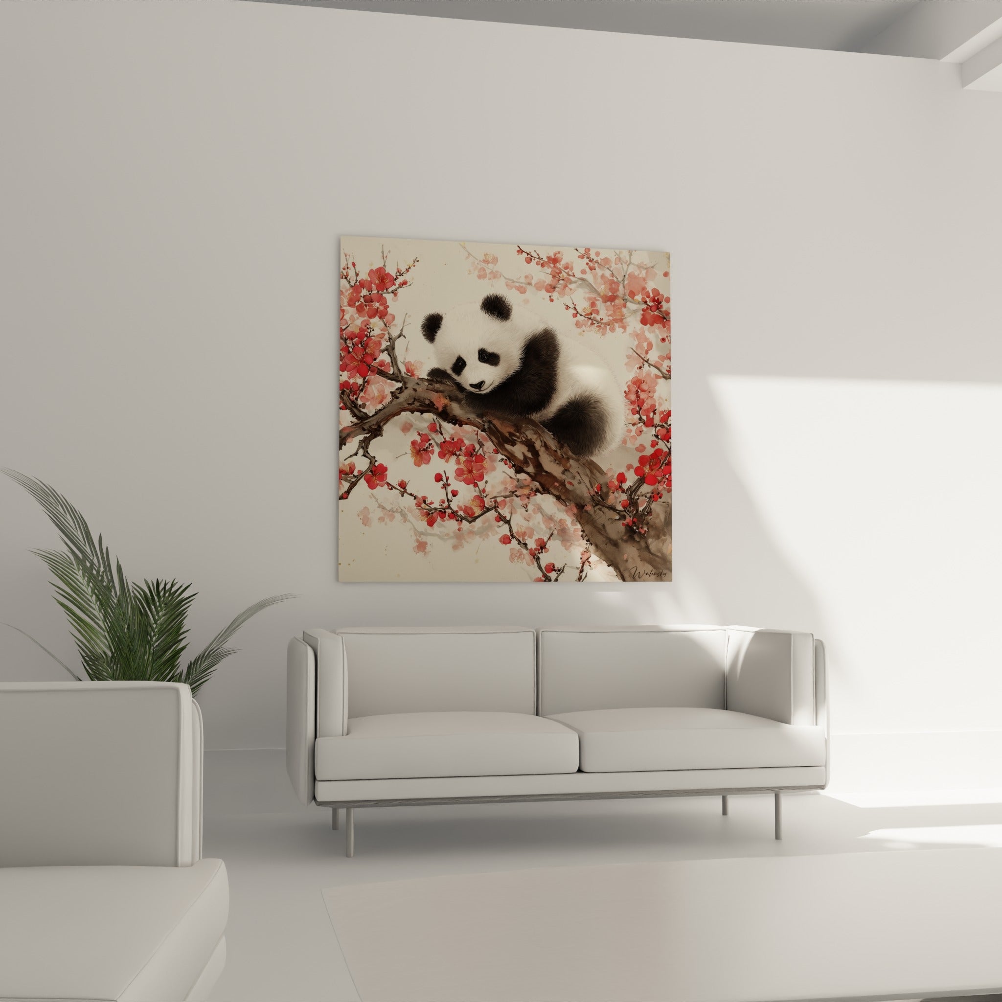 Ourson panda noir et blanc niché sur une branche fleurie, au-dessus d'un canapé dans un salon lumineux
