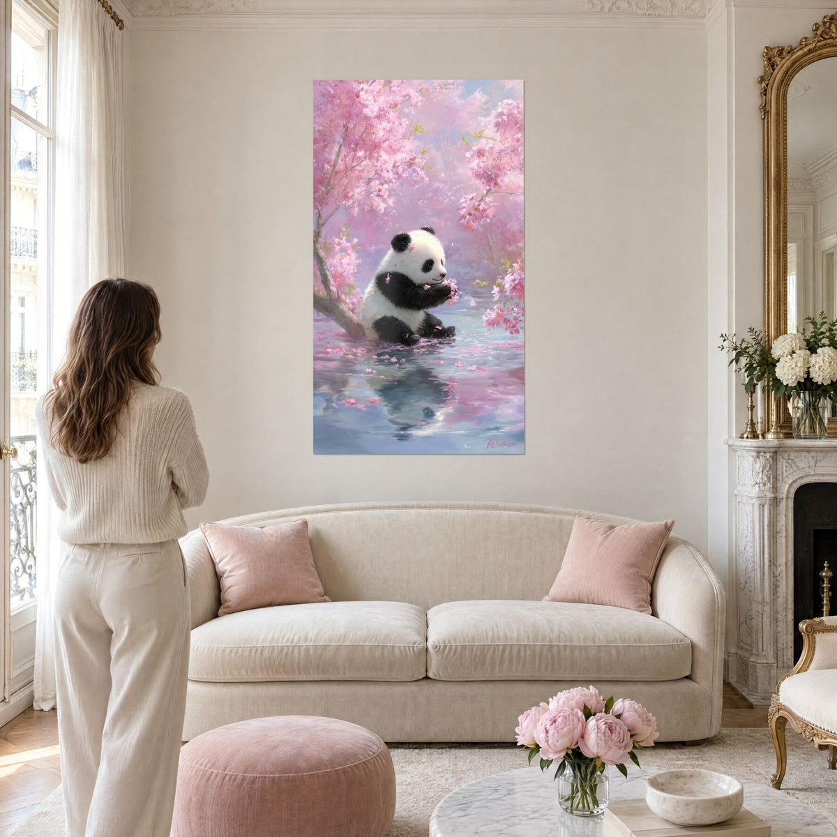 Wall art Chubby panda on pink and pastel blue cherry blossom, woman seen from behind above a sofa in a bright living room