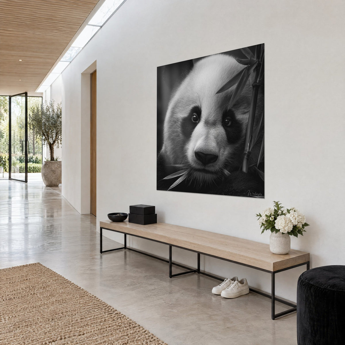 Wall art close-up portrait of a bamboo bear, black muzzle and ivory fur, white wall, wooden bench and glass-walled corridor