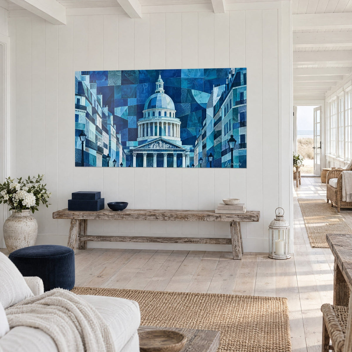 Cuadro cúpula neoclásica en patchwork índigo y turquesa, frontón esculpido, farolas negras, sobre el muro blanco de una casa junto al mar