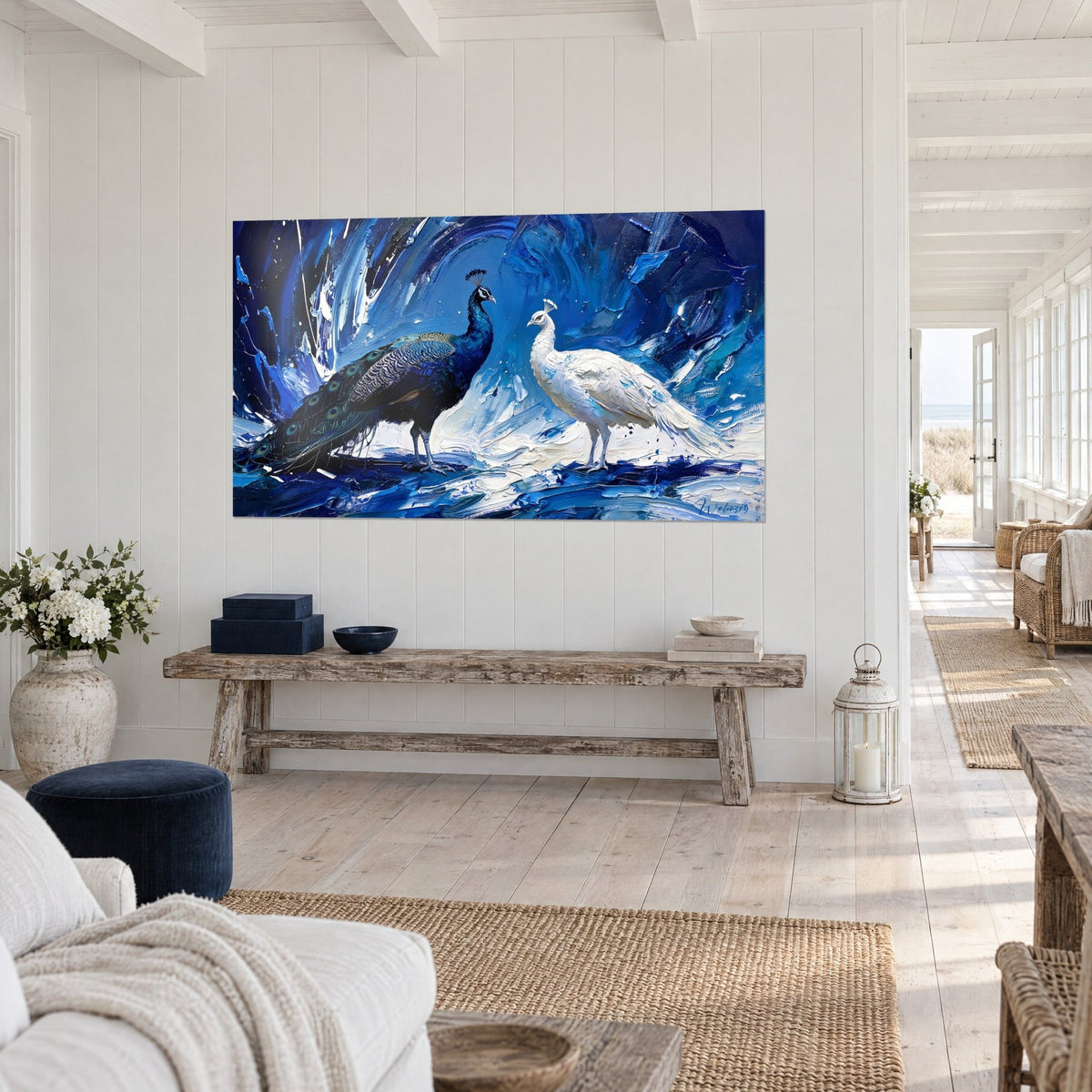 Wall art pair of birds in night-and-snow plumage, thick cobalt blue and white paint, hung in a seaside home