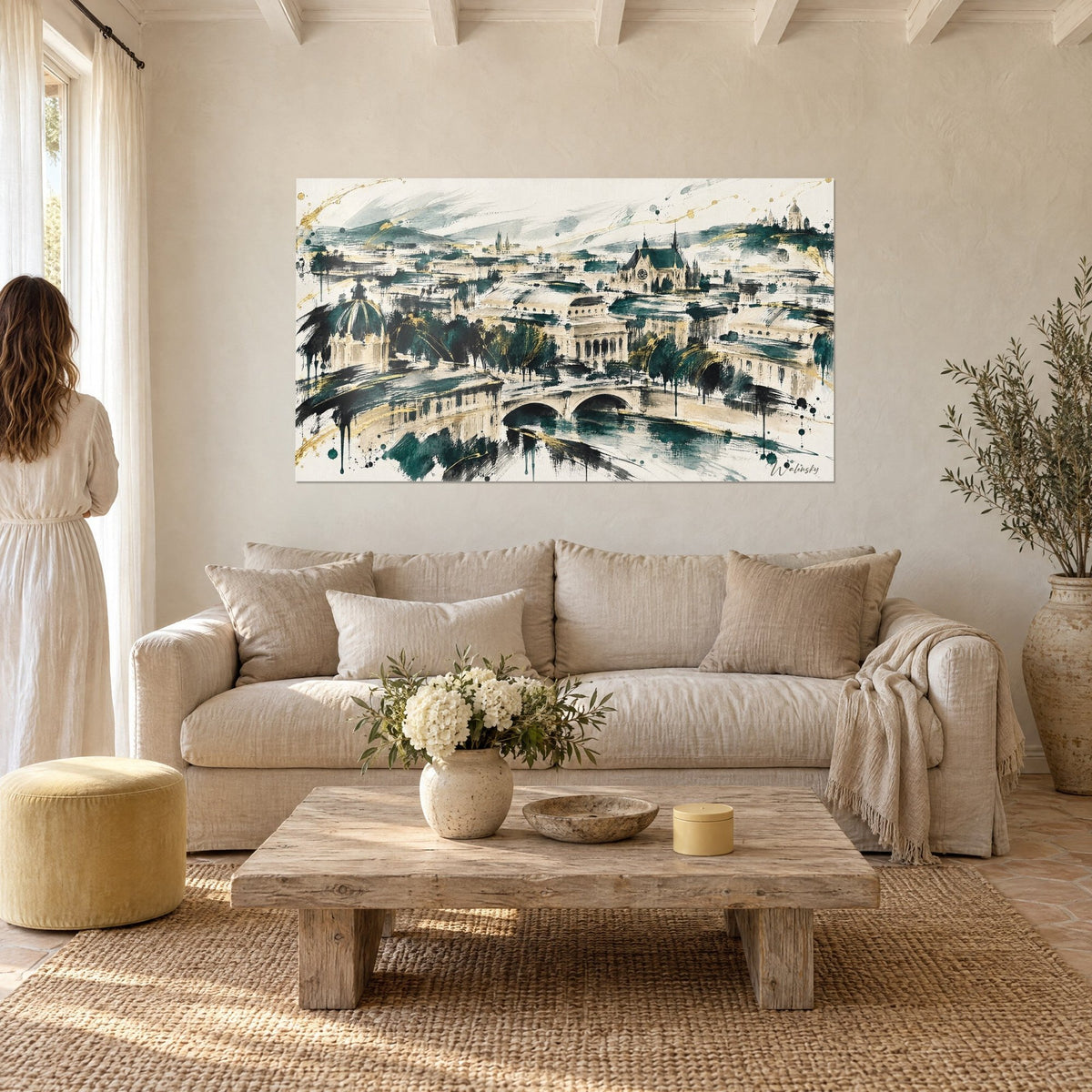 Wall art stone bridge over the Seine in emerald green and gold, dome and ivory rooftops, above a sofa in a bright living room