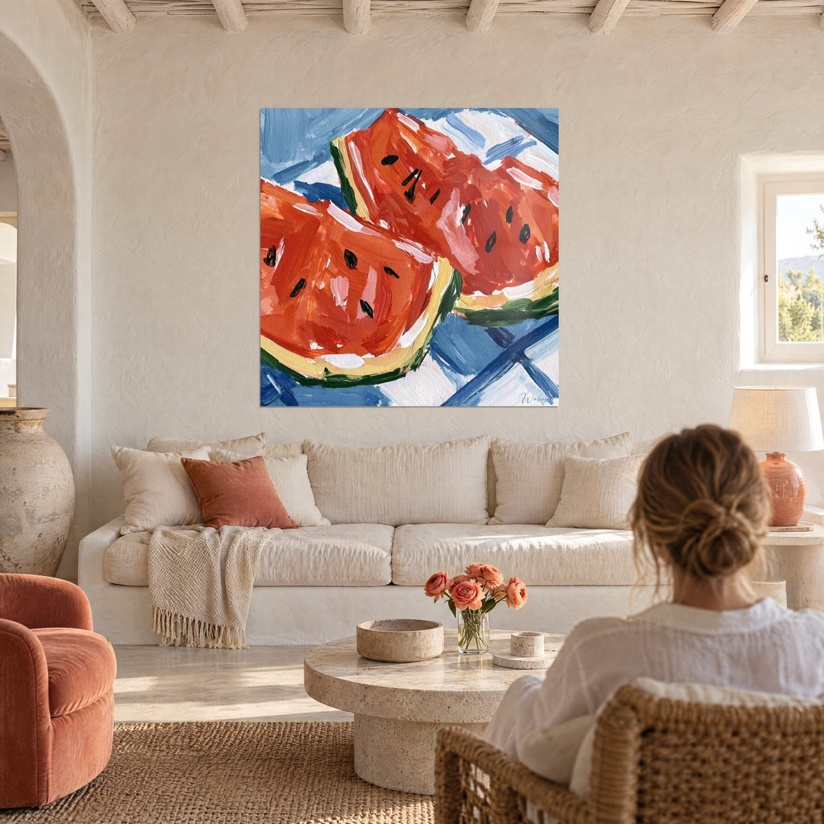 Wall art of a sliced watermelon in vermilion red and gingham blue, thick brushstrokes, above a sofa in a bright living room