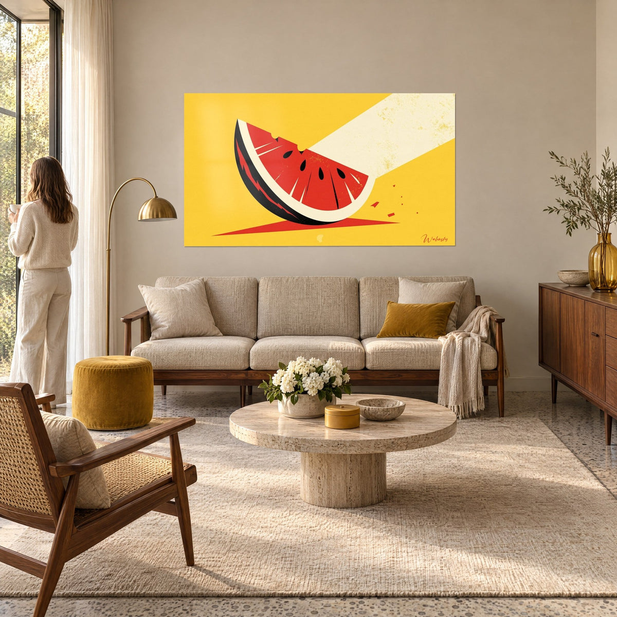 Wall art red watermelon slice bitten on a yellow background, cream light beam, woman seen from behind, above a sofa in a bright living room