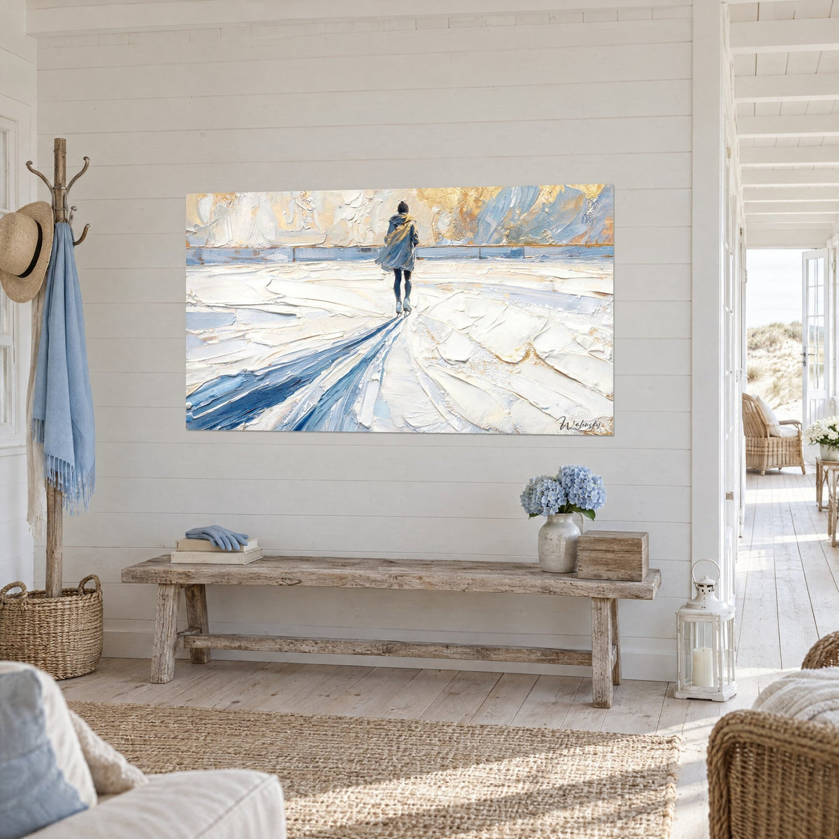 Wall art of a silver-hooded silhouette on an ice rink of ivory and blue impasto, hung in a seaside living room